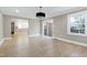 Dining area with hardwood floors and view into kitchen at 5317 Ten Ten Rd, Apex, NC 27539