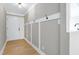 Light-filled entry hall with wainscoting and hardwood floors at 5317 Ten Ten Rd, Apex, NC 27539
