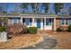 Charming brick house with a blue door and manicured landscaping at 5317 Ten Ten Rd, Apex, NC 27539