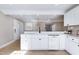 Bright kitchen boasts white cabinets, marble countertops, and stainless steel appliances at 5317 Ten Ten Rd, Apex, NC 27539