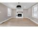Cozy living room features a white brick fireplace and hardwood floors at 5317 Ten Ten Rd, Apex, NC 27539