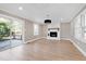 Living room with fireplace, hardwood floors, and sliding glass doors to deck at 5317 Ten Ten Rd, Apex, NC 27539