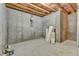 Unfinished basement area ready for customization with exposed ceiling and concrete walls at 664 Long Melford Dr, Rolesville, NC 27571