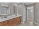 Bathroom featuring double sinks with vanity, framed mirrors, and access to the walk-in closet at 664 Long Melford Dr, Rolesville, NC 27571
