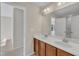 Bathroom with double sink vanity, a large mirror and neutral walls at 664 Long Melford Dr, Rolesville, NC 27571