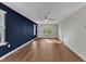 Bright bonus room boasts hardwood flooring, a ceiling fan, and plenty of natural light at 664 Long Melford Dr, Rolesville, NC 27571