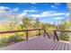 Large, sunny outdoor wooden deck with a view of the surrounding trees at 664 Long Melford Dr, Rolesville, NC 27571