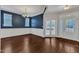 Bright dining room with dark accent wall, wainscoting and french doors at 664 Long Melford Dr, Rolesville, NC 27571