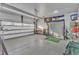 Spacious two car garage featuring epoxy floor, overhead storage and tool bench at 664 Long Melford Dr, Rolesville, NC 27571