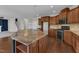 Kitchen boasts stone countertops and backsplash, stainless steel appliances, and wood floors at 664 Long Melford Dr, Rolesville, NC 27571