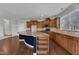 Kitchen boasts granite counters, wooden cabinets, and an island with barstool seating at 664 Long Melford Dr, Rolesville, NC 27571
