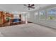 Bright living area with a ceiling fan, large windows, and hardwood floors connecting to a modern kitchen at 664 Long Melford Dr, Rolesville, NC 27571