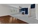 Open concept living area with a fireplace, staircase, and built-in shelving, bathed in natural light at 664 Long Melford Dr, Rolesville, NC 27571