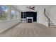 Spacious living room with a fireplace, built-in shelves, and large windows providing lots of natural light at 664 Long Melford Dr, Rolesville, NC 27571