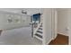 Bright living room features large windows, ceiling fan and a fireplace next to a staircase at 664 Long Melford Dr, Rolesville, NC 27571
