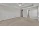 Spacious main bedroom with neutral walls and carpet, ceiling fan, and access to a walk-in closet and ensuite bathroom at 664 Long Melford Dr, Rolesville, NC 27571