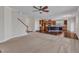 Open floorplan with carpeted living area leading to hardwood kitchen at 664 Long Melford Dr, Rolesville, NC 27571