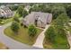 Aerial view of a luxurious house in a tree-lined neighborhood at 7440 Bleasdale Ct, Apex, NC 27539