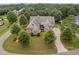 Bird's eye view of a luxurious house with a circular driveway and lush landscaping at 7440 Bleasdale Ct, Apex, NC 27539