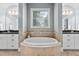 Spa-like bathroom with a free-standing tub and double vanity at 7440 Bleasdale Ct, Apex, NC 27539