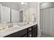 Double vanity bathroom with dark brown cabinets and a shower at 7440 Bleasdale Ct, Apex, NC 27539