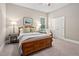 Cozy bedroom with wood bed frame, window with blinds, and nightstands at 7440 Bleasdale Ct, Apex, NC 27539