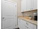 Bright butler's pantry with granite countertops and white cabinets at 7440 Bleasdale Ct, Apex, NC 27539