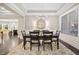 Bright dining room with chandelier, hardwood floors, and kitchen access at 7440 Bleasdale Ct, Apex, NC 27539