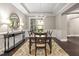 Formal dining room with dark hardwood floors, chandelier, and view to kitchen at 7440 Bleasdale Ct, Apex, NC 27539