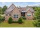 Stone and shingle exterior of a two-story home with manicured landscaping at 7440 Bleasdale Ct, Apex, NC 27539