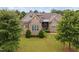 Stone and shingle two-story house with a large yard and mature trees at 7440 Bleasdale Ct, Apex, NC 27539