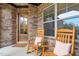 Front porch with rocking chairs and a view of the home's entrance at 7440 Bleasdale Ct, Apex, NC 27539