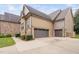 Two-car attached garage with stone and siding exterior at 7440 Bleasdale Ct, Apex, NC 27539