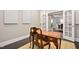 Bright home office features a wooden desk and view to dining area at 7440 Bleasdale Ct, Apex, NC 27539