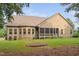 Tan house exterior with a large screened porch and manicured lawn at 7440 Bleasdale Ct, Apex, NC 27539