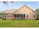 Tan house exterior with a large screened porch and manicured lawn at 7440 Bleasdale Ct, Apex, NC 27539
