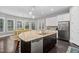 Modern kitchen with granite island, stainless steel appliances, and ample cabinetry at 7440 Bleasdale Ct, Apex, NC 27539
