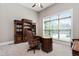Home office with large desk, built-in bookcases, and window views at 7440 Bleasdale Ct, Apex, NC 27539