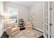 Cozy office with two armchairs and built-in shelving at 7440 Bleasdale Ct, Apex, NC 27539
