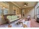 Relaxing screened porch with wicker furniture and wood flooring at 7440 Bleasdale Ct, Apex, NC 27539