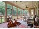 Relaxing screened porch with wicker furniture and wood flooring at 7440 Bleasdale Ct, Apex, NC 27539