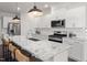 Modern kitchen with white cabinets, granite countertops, and large island at 776 Denburn Pl, Raleigh, NC 27603