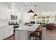 Modern kitchen with white cabinets, granite countertops, and large island at 776 Denburn Pl, Raleigh, NC 27603