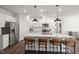 Modern kitchen with white cabinets, granite countertops, and large island at 776 Denburn Pl, Raleigh, NC 27603