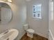 Small bathroom with white vanity, toilet, and window at 902 Laurel Gate Dr, Wake Forest, NC 27587