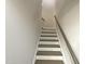 Modern staircase with wood steps and a simple handrail at 902 Laurel Gate Dr, Wake Forest, NC 27587