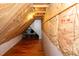 Attic featuring hardwood floor and fiberglass insulation at 9412 Harvest Acres Ct, Raleigh, NC 27617