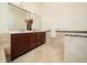 Bathroom featuring a double vanity with stylish fixtures and tiled walls at 9412 Harvest Acres Ct, Raleigh, NC 27617