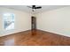 An airy bedroom features a ceiling fan and a window letting in natural light at 9412 Harvest Acres Ct, Raleigh, NC 27617