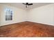 This bright, spacious bedroom features hardwood floors, a large window, ceiling fan, and neutral walls at 9412 Harvest Acres Ct, Raleigh, NC 27617